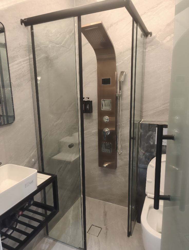 Service apartment bathroom glass shower enclosure